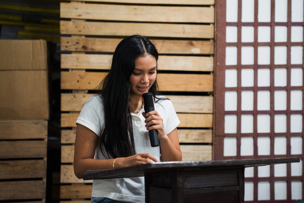 Athalia Suarez smiles while speaking at a lectern.