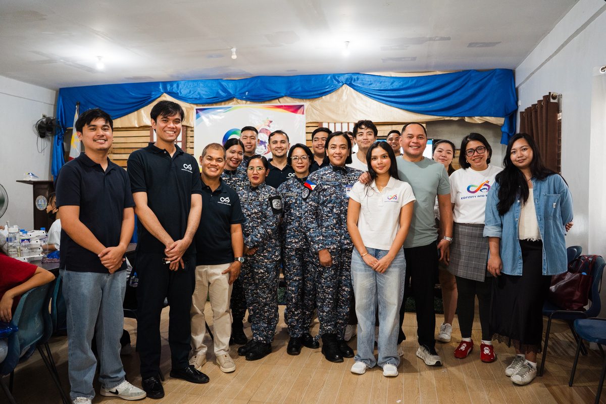 Foundation staff, jail officers in uniform and guests stand together for a group photograph.