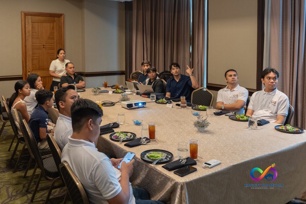Foundation members and the communications team around a long dining table.