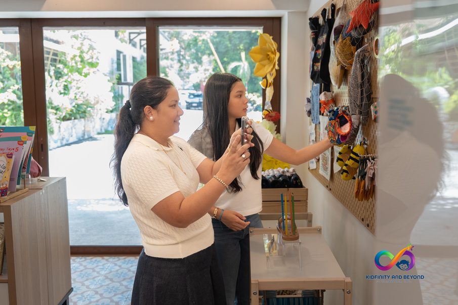 Mrs. Huang shows Athalia Suarez a display of handcrafted items.